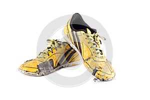 Old yellow futsal sports shoes and the insole is damaged  on white background football sportware object isolated