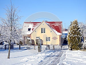 Old yellow home and snowy trees, Lithuania