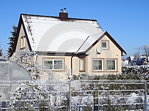 Old yellow home and snowy trees, Lithuania