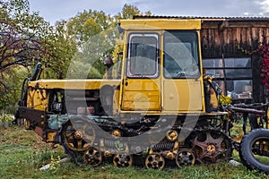 An old yellow rusted crawler tractor
