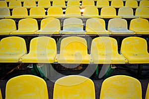 Old yellow seat in stadium closeup