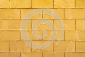 Old yellow stone block wall background