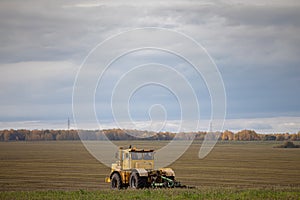 old yellow tractor running in the field