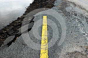 Old yellow traffic lines on the road