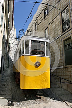 Old yellow tram standing in the street of Lisbon