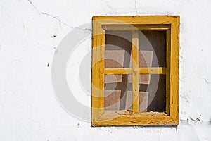 Old Yellow Window on Cracked Wall