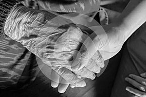Old and young hands check hand black and white