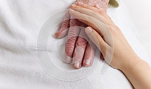 Old and Young Hands on White Blanket