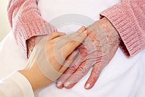 Old and Young Hands on White Blanket