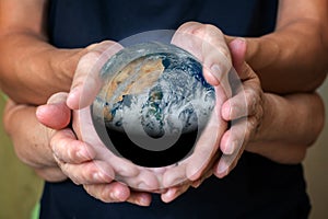 old and young person hands holding planet earth, unity concept. elements of this images furnished by nasa