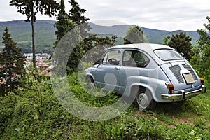 An old Yugoslav-made Citroen stands on an elephant mountain overlooking Lake Ohrid, North Macedonia