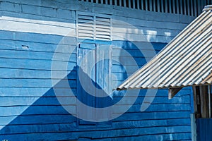 Old zinc roof and shadow on blue wooden wall