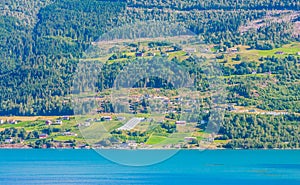 Olden, Norway, typical summer panorama of Norwegian village landscape, mountains and colorful traditional nordic houses