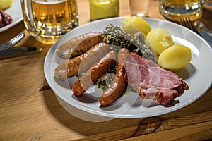 Oldenburger green cabbage with sausage mix, Kassler pork neck, boiled potatoes, mustard, beer and grain liquor is an traditional