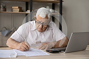 Older 80s landlord man, tenant checking paper domestic bills