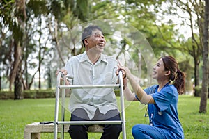 Older Adult Receive Encouragement and Good Treatment from Caregivers While Sitting Relaxed in The Green Park. Traits of a Quality