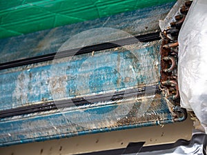 Older air conditioner in the wash. After not maintaining it for a long time. Dusty interior And the parts are rusty. Accumulating