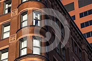 Older architectural brick and stone office building with french turret