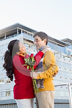 Older asian couple on balcony with roses