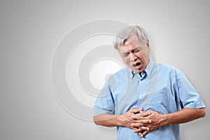 Older asian man is having stomach ache pain concept with isolated background. Senior or mature people suffering from digestion