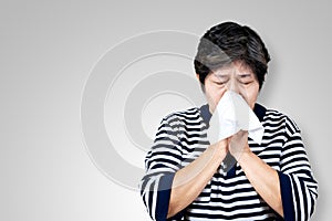 Older asian woman is having flu and sneezing from sickness seasonal virus problem