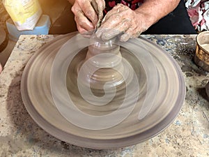 An older Asian woman Are making pottery by hand