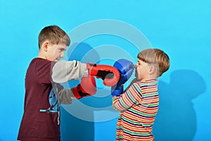 The older brother of the boxer beats the younger, and he defends himself and holds the blow