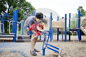 Older brother helping disabled sibling