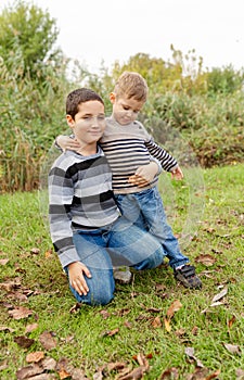 Older brother hugging his younger brother. Happy family. Brother love