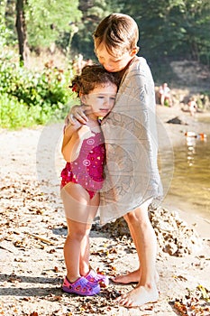 Older brother hugs his sister