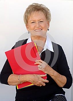 Older business woman with file folders