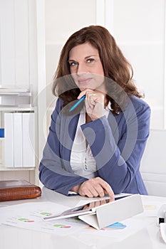 Older business woman sitting in her office.