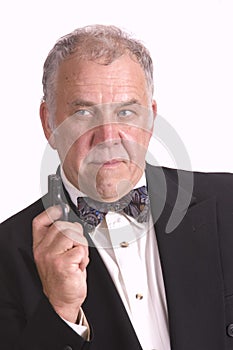 Older businessman impersonating James Bond photo