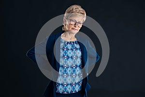 Older businesswoman having lower back pain