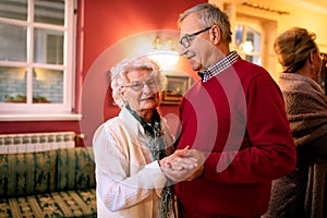 Older couple dancing in the room