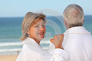 Older couple outdoors in bathrobes