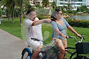 Older couple riding bicycles in the city