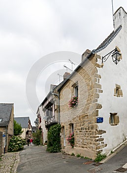 Older couple walks through the narrow streets of an idyllic French village