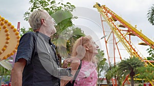 Older couples are visiting amusement parks, they are fun like children. Until forgetting about my own age