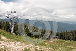 Older double chairlifts at Seymour Mountain with scenic view in the background