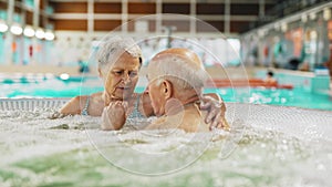 Older etired man and woman relaxing in the bubbly spa hot tub