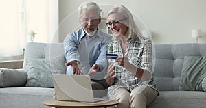 Older family makes purchases using computer and credit card