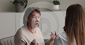 Older female telling about health complaints to reliable doctor