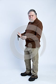 Older gentleman holding picture frame and scowling