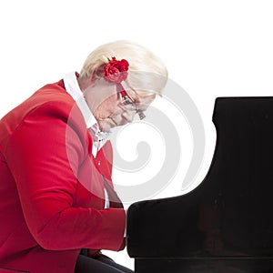 Older lady in red playing the grand piano