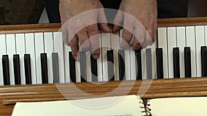 Older Male Hands Playing Piano Top Down View