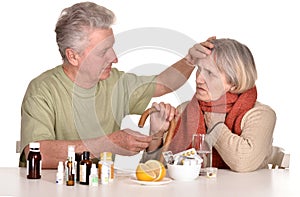 Older man caring for sick woman