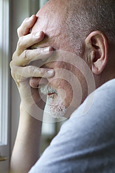 Older man expressing pain or depression, vertical