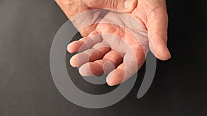 Older man has finger tremors