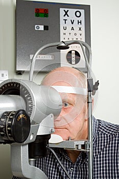 Older man having eye examination photo